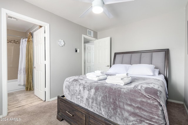 bedroom featuring ceiling fan, light colored carpet, and a closet