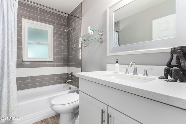 full bathroom with shower / bath combo with shower curtain, vanity, hardwood / wood-style floors, and toilet