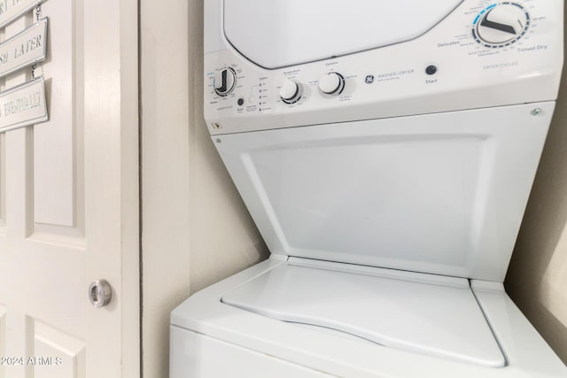 laundry area featuring stacked washer / drying machine