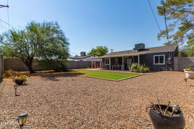 rear view of property with central AC and a patio