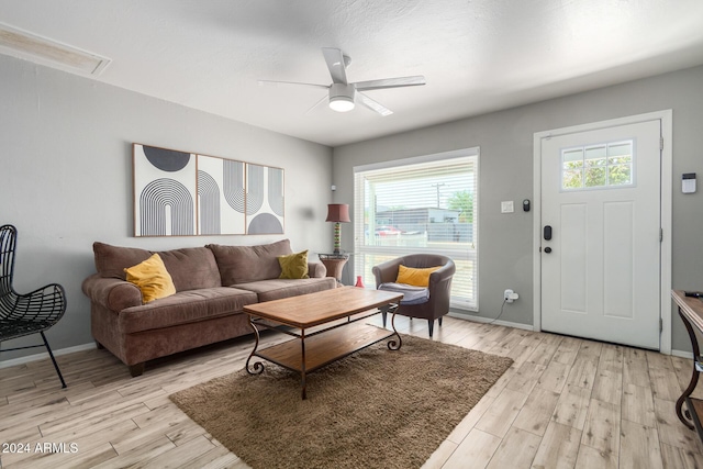 living room with ceiling fan, a healthy amount of sunlight, and light hardwood / wood-style floors