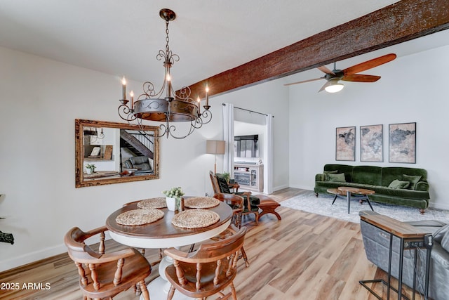 dining room with a ceiling fan, wood finished floors, and baseboards