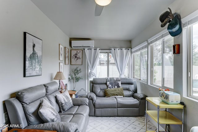 living area featuring ceiling fan and a wall mounted AC