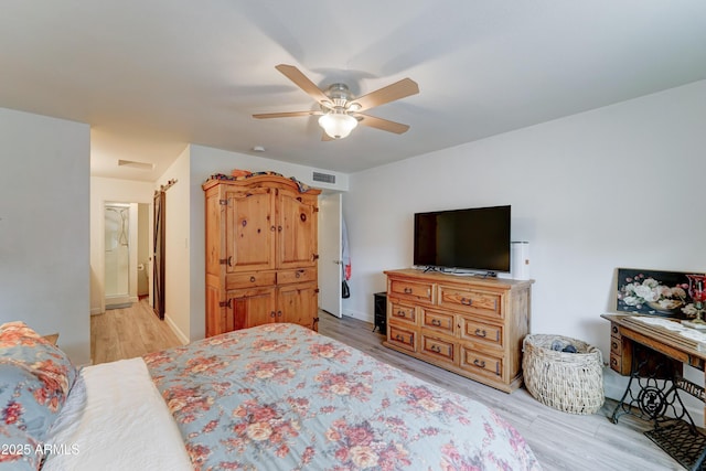 bedroom featuring a ceiling fan, visible vents, light wood finished floors, and baseboards