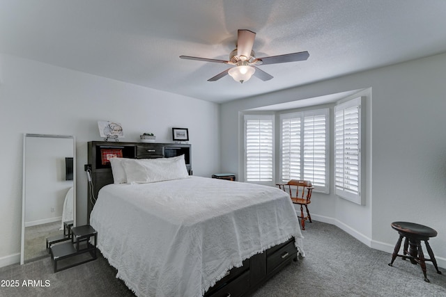 bedroom featuring a textured ceiling, baseboards, carpet, and a ceiling fan