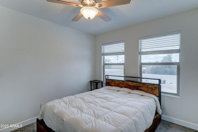 carpeted bedroom featuring baseboards and ceiling fan