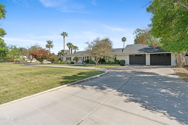 ranch-style home with an attached garage, driveway, and a front lawn