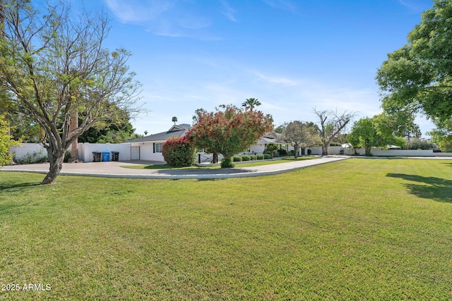 exterior space with fence and a front yard
