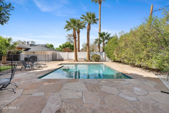 view of swimming pool with a fenced in pool, a fenced backyard, and a patio area
