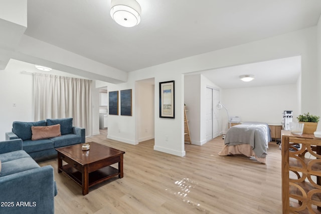 living room featuring baseboards and light wood-type flooring