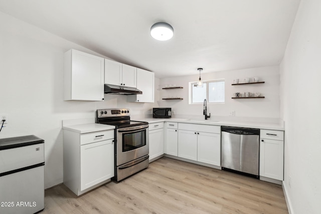 kitchen with open shelves, a sink, appliances with stainless steel finishes, and under cabinet range hood