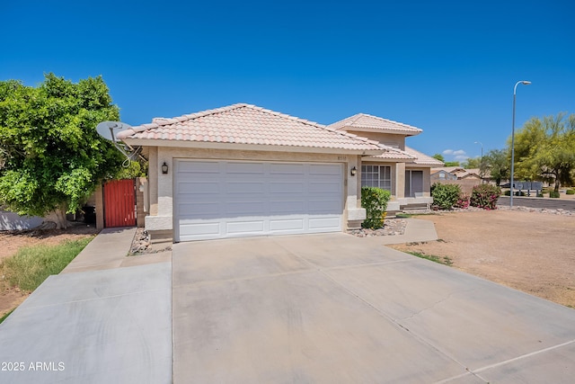 8510 W Joan De Arc Ave, Peoria, AZ 85381 - ranch-style house with fence, stucco siding, an attached garage, a tile roof, and concrete driveway