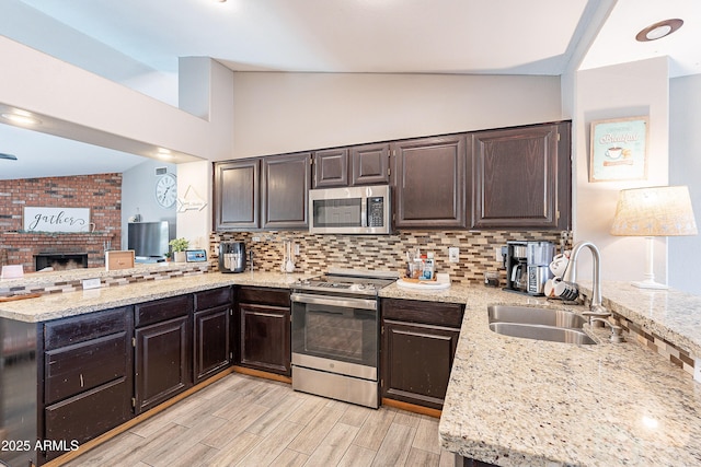 8510 W Joan De Arc Ave, Peoria, AZ 85381 - kitchen featuring a peninsula, decorative backsplash, stainless steel appliances, and a sink