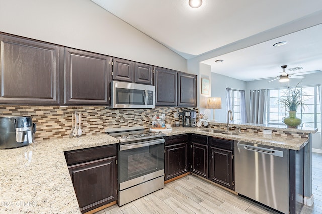 8510 W Joan De Arc Ave, Peoria, AZ 85381 - kitchen with a sink, backsplash, lofted ceiling, ceiling fan, and appliances with stainless steel finishes