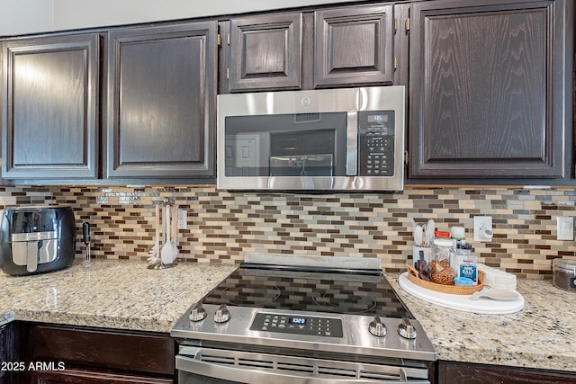 8510 W Joan De Arc Ave, Peoria, AZ 85381 - kitchen with backsplash, dark brown cabinetry, and stainless steel appliances