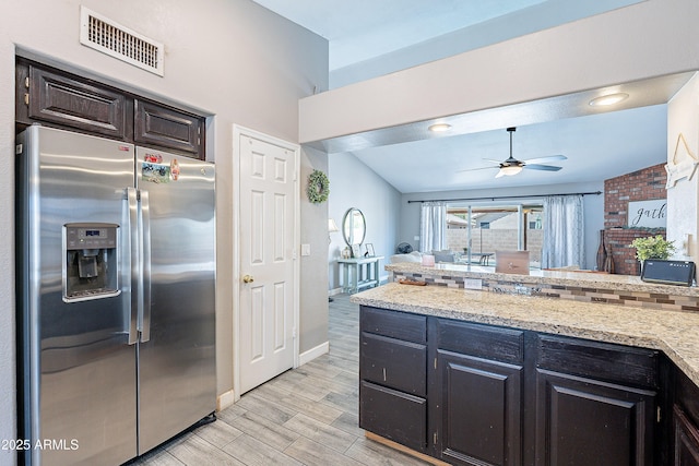 8510 W Joan De Arc Ave, Peoria, AZ 85381 - kitchen featuring a ceiling fan, light wood-type flooring, stainless steel fridge, light stone countertops, and visible vents