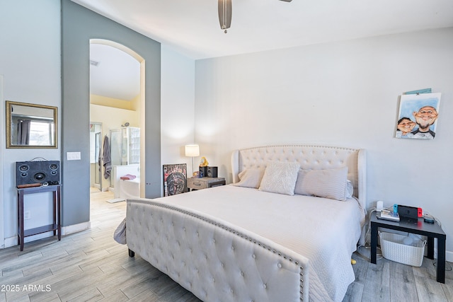 8510 W Joan De Arc Ave, Peoria, AZ 85381 - bedroom with arched walkways, light wood-style flooring, a ceiling fan, and ensuite bathroom