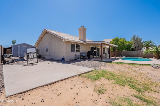 8510 W Joan De Arc Ave, Peoria, AZ 85381 - rear view of house featuring a storage shed, a fenced backyard, an outdoor structure, a patio, and stucco siding