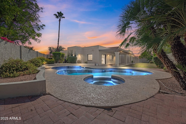 view of pool with a fenced backyard, a fenced in pool, a patio, and an in ground hot tub