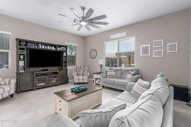 living room featuring light tile patterned floors and ceiling fan