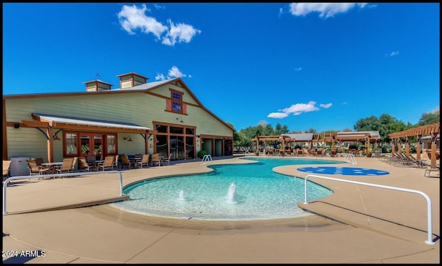 view of swimming pool featuring a patio area and pool water feature