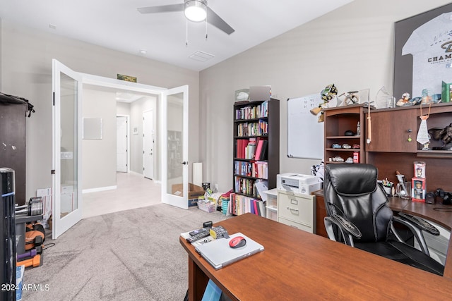 carpeted home office featuring ceiling fan, vaulted ceiling, and french doors