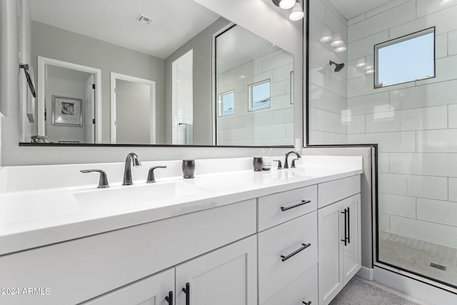 bathroom featuring a wealth of natural light, an enclosed shower, and vanity