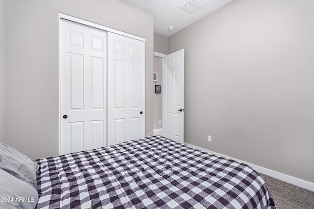 bedroom with carpet and a closet