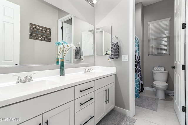 bathroom featuring tile patterned floors, toilet, and vanity