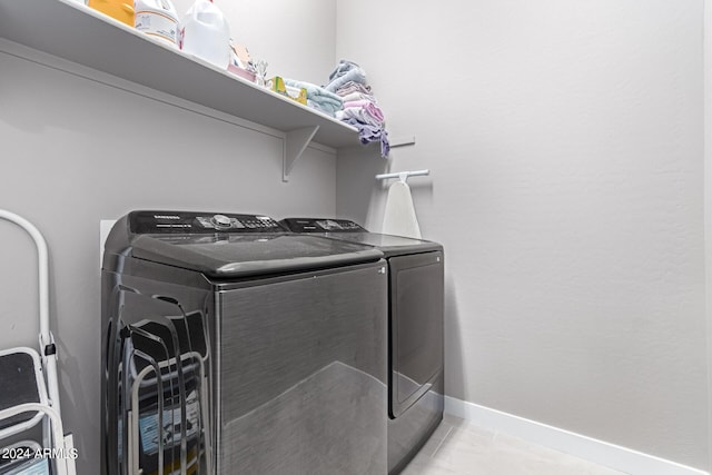 washroom featuring washer and dryer and light tile patterned floors