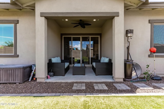 view of exterior entry with an outdoor hangout area, ceiling fan, and a patio area