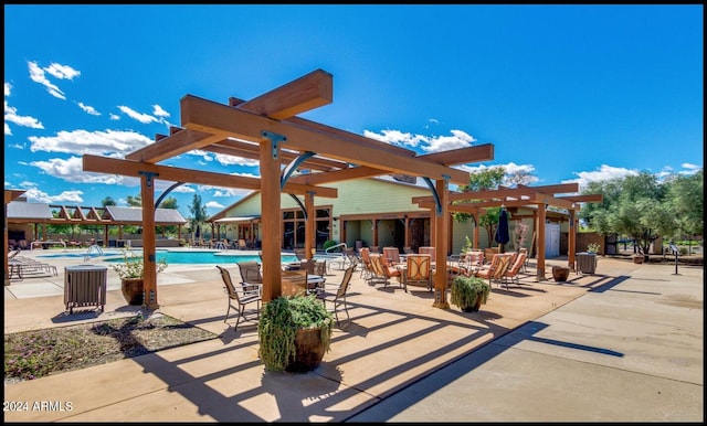 view of patio / terrace featuring a pergola and a community pool