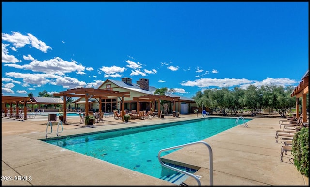 view of pool with a patio area and a pergola