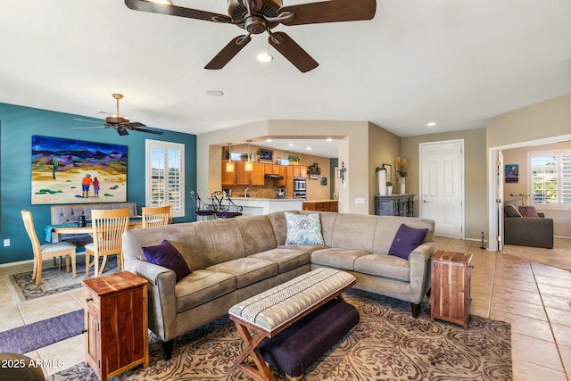 living area featuring light tile patterned floors, recessed lighting, and baseboards