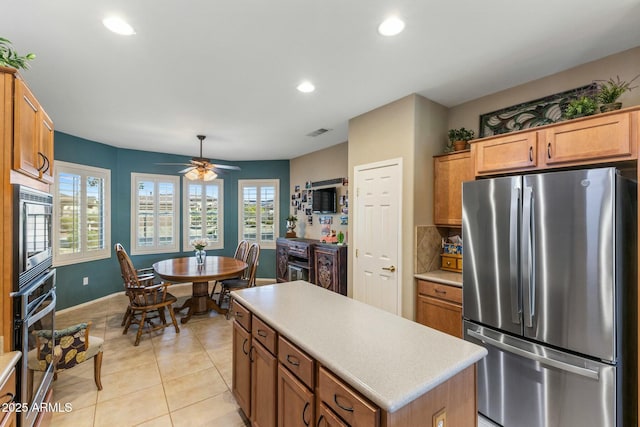 kitchen featuring a kitchen island, recessed lighting, stainless steel appliances, and light countertops