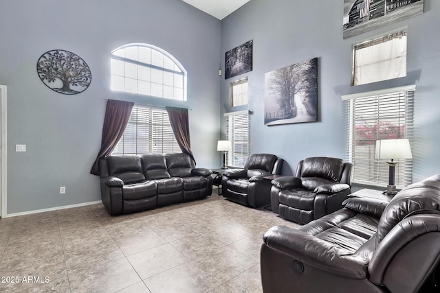 living room featuring a towering ceiling and light tile patterned flooring