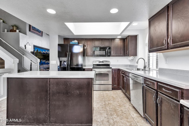 kitchen with sink, dark brown cabinets, black appliances, a textured ceiling, and a kitchen island