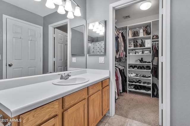 bathroom featuring tile patterned flooring and vanity