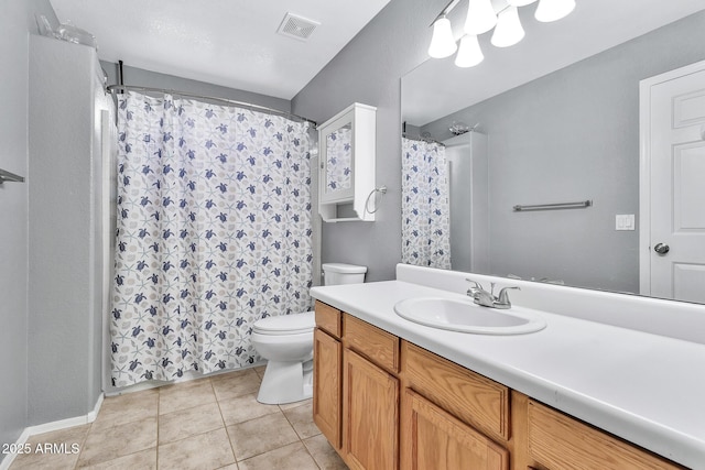 bathroom with tile patterned flooring, vanity, and toilet