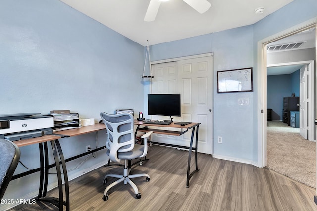 home office featuring wood-type flooring and ceiling fan