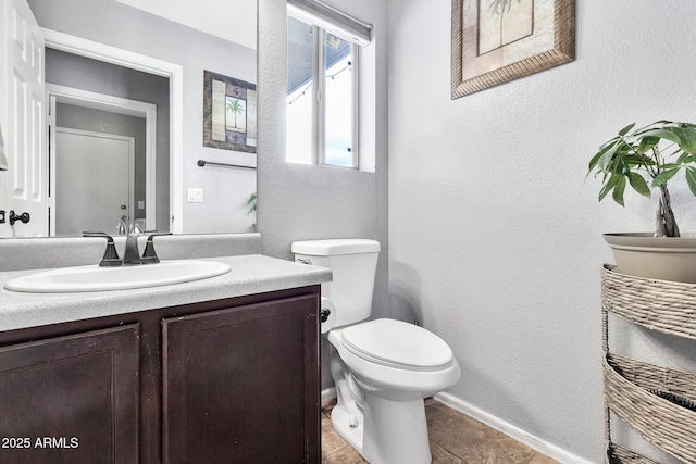 bathroom with vanity, toilet, and tile patterned flooring