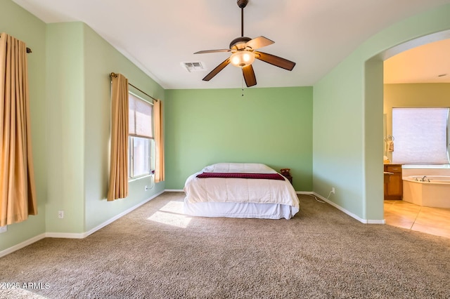 bedroom with visible vents, arched walkways, baseboards, and carpet flooring