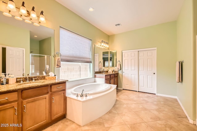 full bath featuring visible vents, two vanities, a sink, a shower stall, and a bath