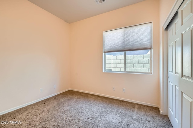 interior space with a closet, baseboards, carpet, and visible vents