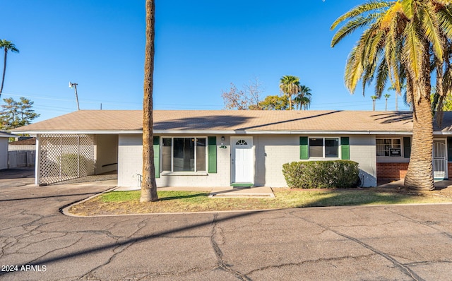 ranch-style home with a carport