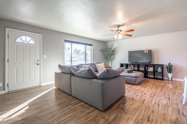 living room featuring a wealth of natural light, hardwood / wood-style floors, and ceiling fan