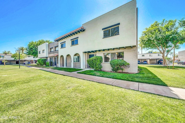 2812 E Clarendon Ave, Phoenix, AZ 85016 - mediterranean / spanish-style house featuring a front lawn, stucco siding, and brick siding