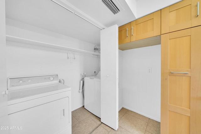 2812 E Clarendon Ave, Phoenix, AZ 85016 - laundry room featuring washer and clothes dryer, light tile patterned floors, and baseboards