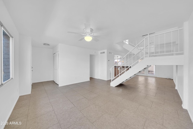 2812 E Clarendon Ave, Phoenix, AZ 85016 - unfurnished living room with stairway, a ceiling fan, baseboards, and tile patterned flooring