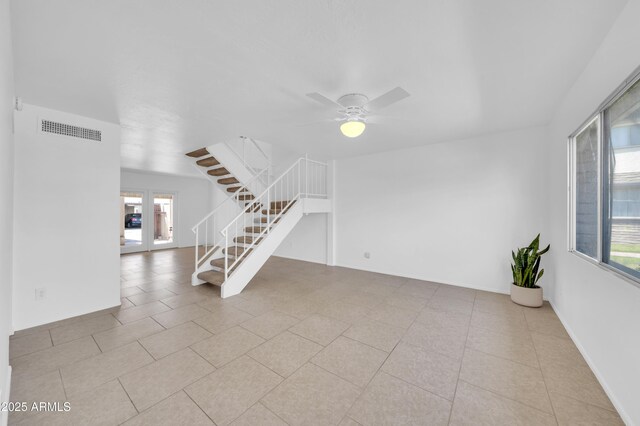 2812 E Clarendon Ave, Phoenix, AZ 85016 - unfurnished living room featuring stairs, ceiling fan, and tile patterned floors